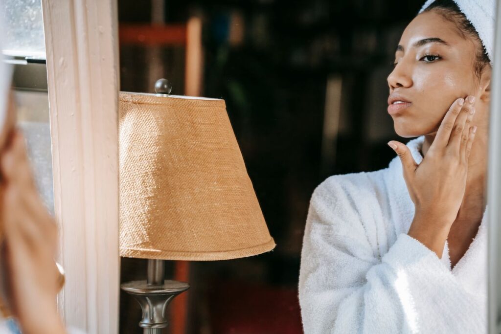 Woman gently touching her cheek to check skin