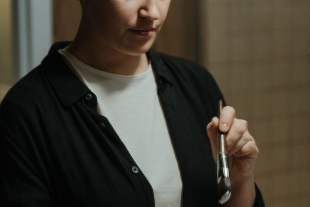 Woman applying skincare product to her face